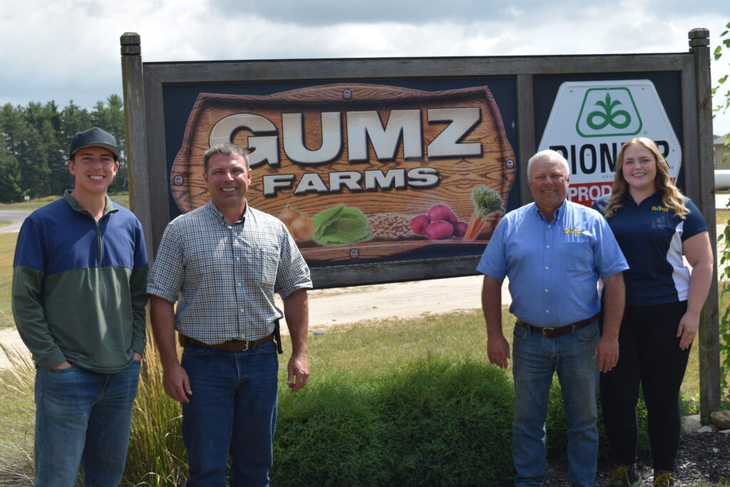 Gumz family in front of Gumz Farms sign